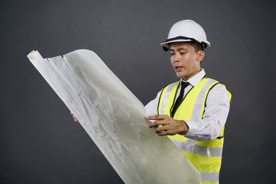 Full length of man wearing hat standing against clear blue sky