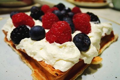 Close-up of dessert with fruits on table