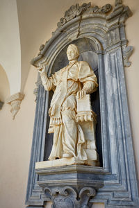 Low angle view of statue against temple