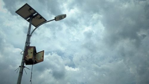 Low angle view of road sign against sky