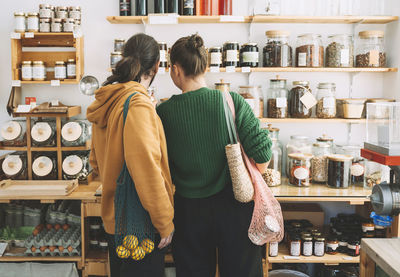 Couple with mesh bags shopping in zero waste store