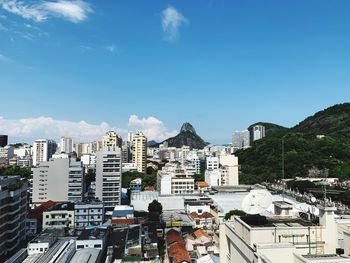 Buildings in city against blue sky