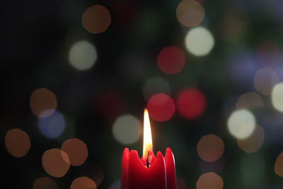 Close-up of illuminated candles against blurred background