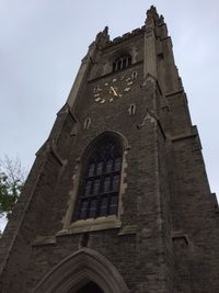 Low angle view of cross against sky