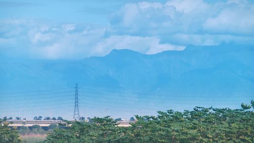 Scenic view of landscape against cloudy sky