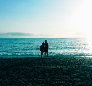 Silhouette man on beach against sky