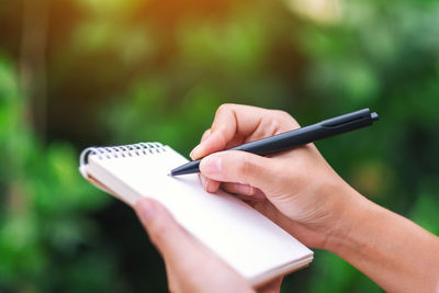 Close-up of woman hand holding smart phone