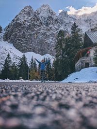 Rear view of man on snowcapped mountain