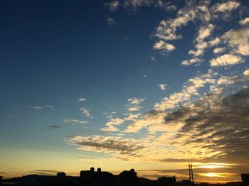 Low angle view of silhouette city against sky