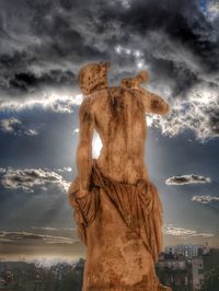 Low angle view of statue against cloudy sky