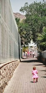 Woman walking on footpath