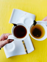 Cropped hand holding coffee cup