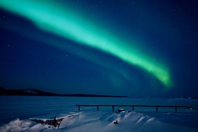 Scenic view of lake against sky at night