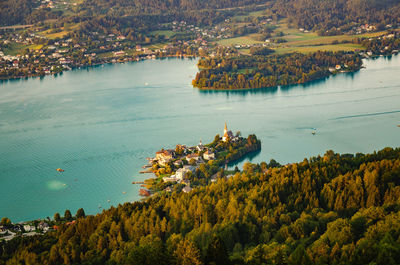 Village maria worth on the lake worthersee in carinthia,austria. sunset landscape