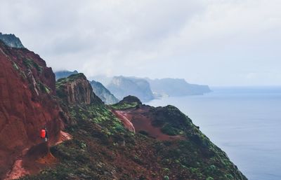 Scenic view of sea and mountains against sky
