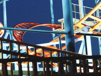 Low angle view of playground against blue sky