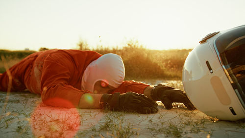 Rear view of man sitting on field