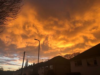Low angle view of silhouette buildings against sky during sunset