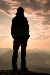 Hiker stand on the sharp corner of sandstone rock in rock empires park and watching over the misty.