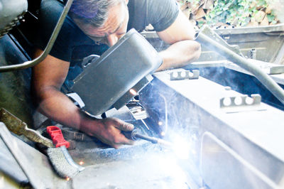 Midsection of man working on table