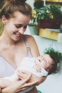 Mother in lingerie holding daughter