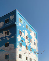 Low angle view of building against blue sky