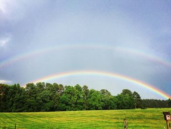 Scenic view of rainbow over field