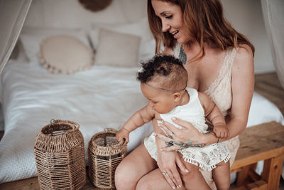 Midsection of mother and daughter at home