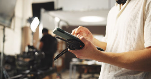 Midsection of man using mobile phone