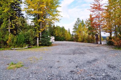 Road amidst trees against sky during autumn