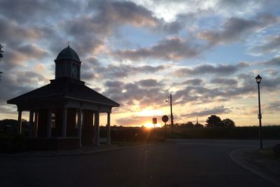 View of road against cloudy sky at sunset