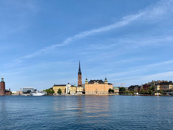 River amidst buildings in city against sky