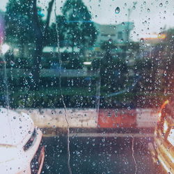 Building seen through wet glass window during monsoon