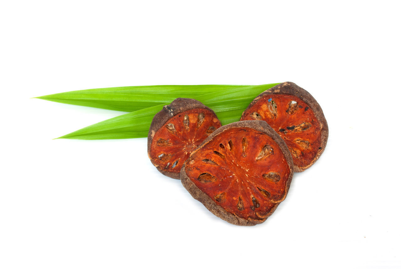 CLOSE-UP OF RED LEAF IN WHITE BACKGROUND