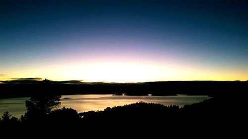 Scenic view of lake against romantic sky at sunset