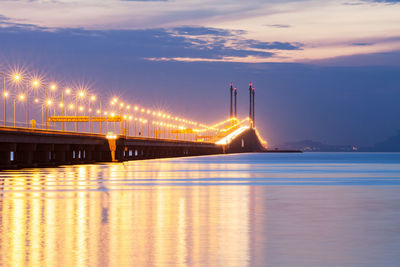 View of suspension bridge in city at night