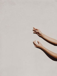 Low section of woman against white background