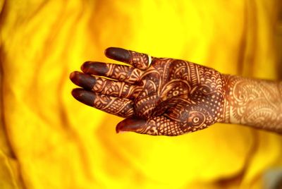 Close-up high angle view of hand showing henna tattoo