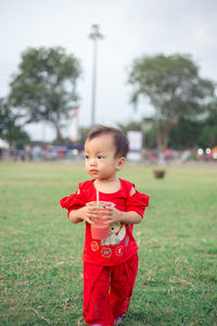 Cute girl standing on field