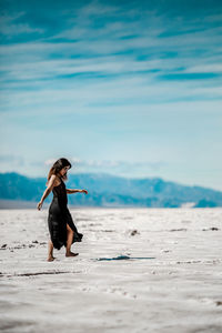 Full length of woman walking on beach