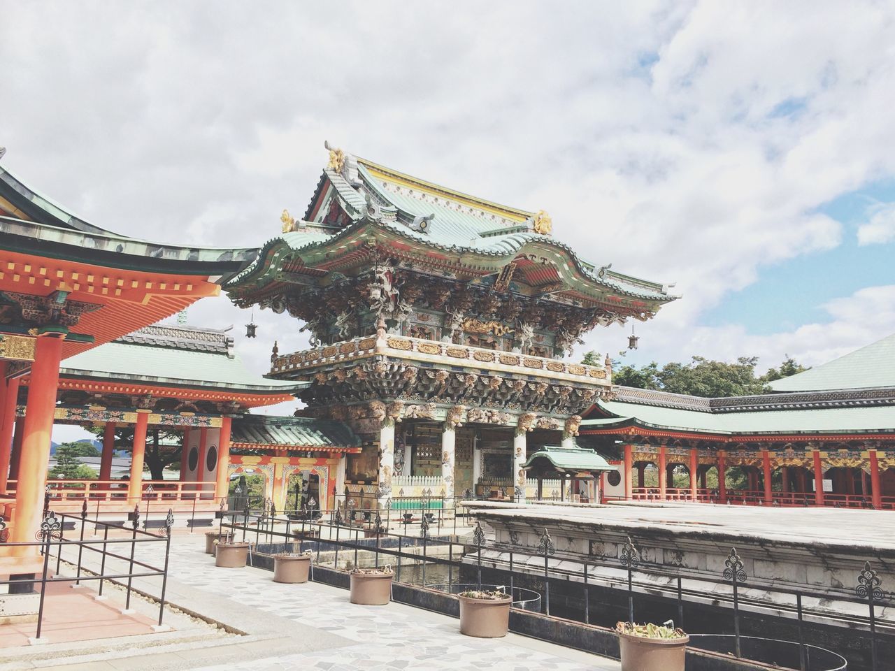 architecture, built structure, building exterior, sky, place of worship, religion, spirituality, temple - building, roof, cloud - sky, tradition, low angle view, steps, cultures, cloud, outdoors, house, travel destinations, day