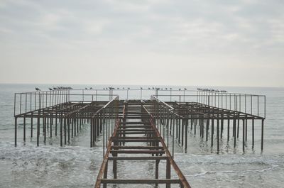 Pier on sea against sky