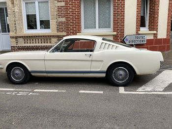 Vintage car parked on street against building