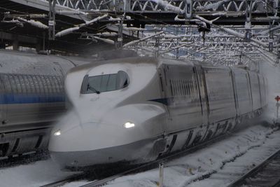 Japanese shinkansen train running in snowy morning