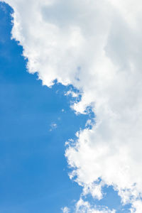 Low angle view of heart shape against blue sky