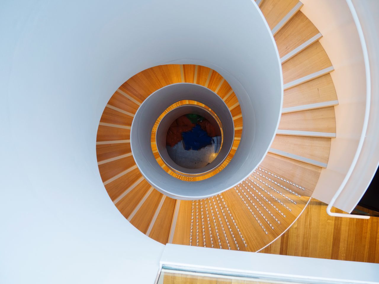 architecture, low angle view, built structure, spiral, steps and staircases, staircase, no people, shape, directly below, sky, indoors, railing, geometric shape, design, pattern, spiral staircase, day, circle, building, digital composite, ceiling
