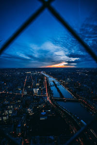 High angle view of city buildings against cloudy sky