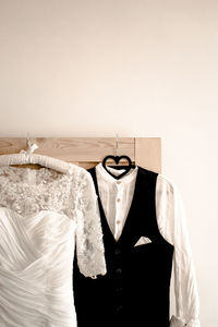 Wedding dress with suit on wall