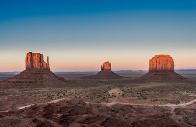 Scenic view of rock formations against sky during sunset