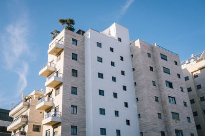 Low angle view of buildings against blue sky